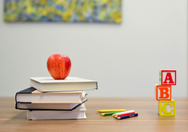 Bücher mit Apfel und Buchstaben des Alphabets
